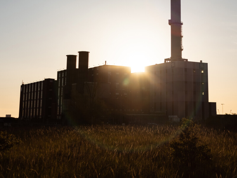 old factory with wheat field around it